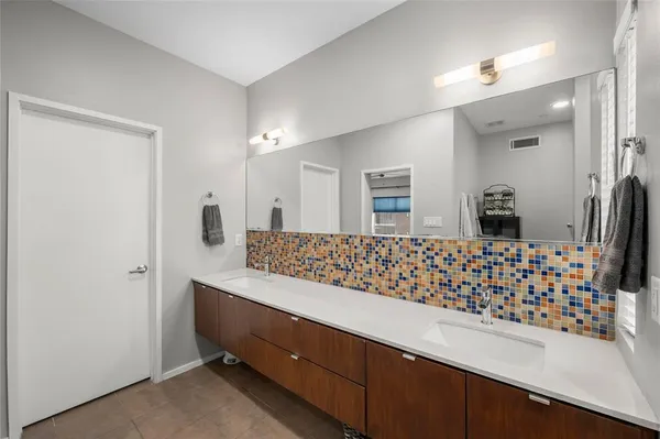 a bathroom with a sink a mirror and shower