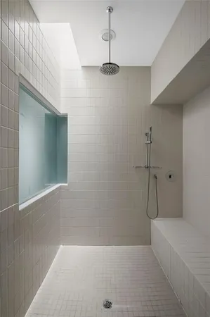 a bathroom with a bathtub and shower