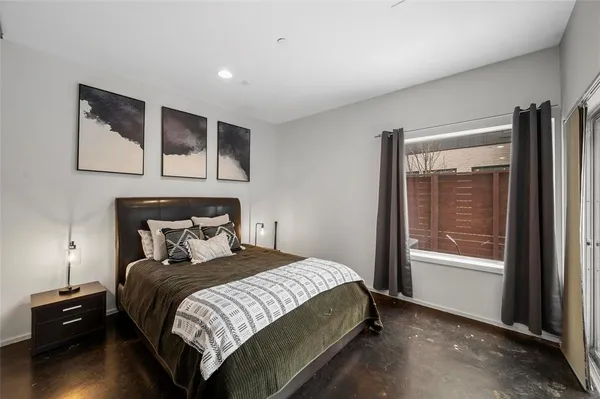 a bedroom with a bed and a night stand
