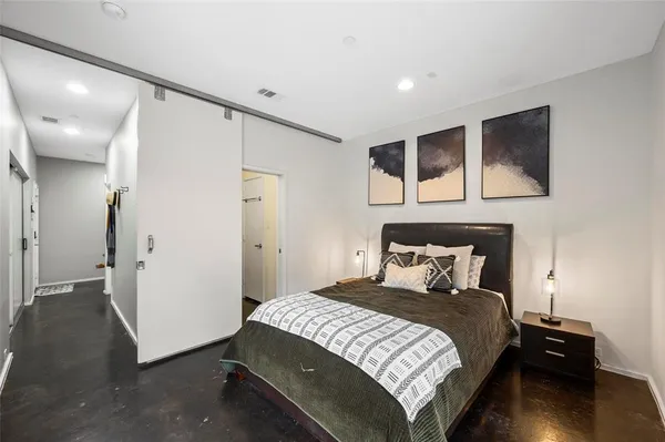 a bedroom with a bed and a view of bathroom