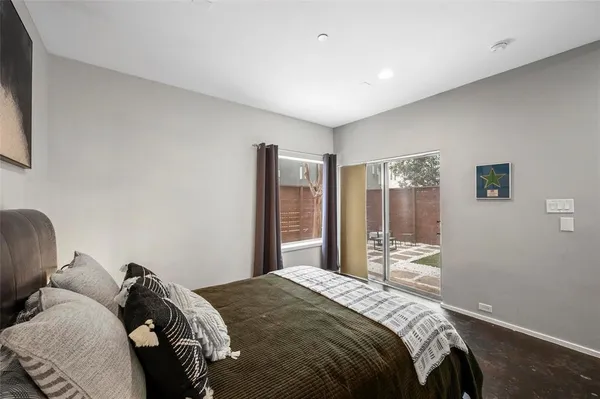 a bedroom with a large bed and a window