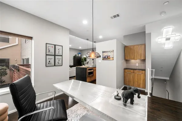 a living room with furniture and a kitchen view