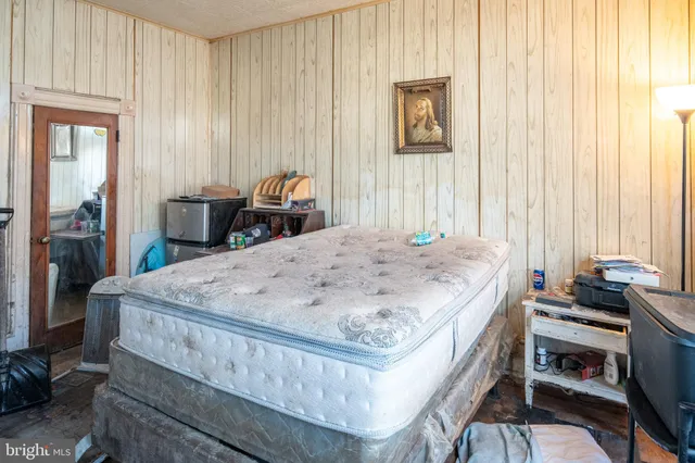 a bedroom with furniture and large windows