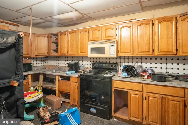 a kitchen with stainless steel appliances wooden cabinets and a stove top oven