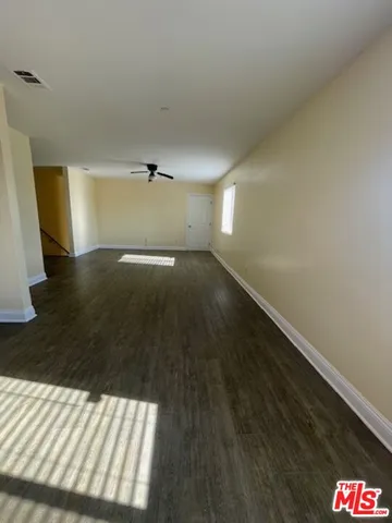 a view of an empty room and wooden floor