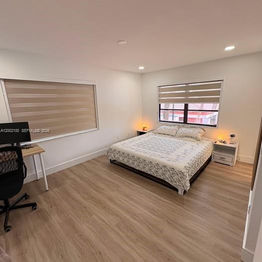 8650 Southwest 149th Avenue, Unit 310 Miami, FL 33193 - Photo 13 of 16 a bedroom with a bed a chair and a large window