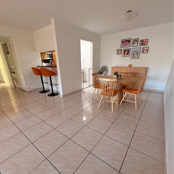 8650 Southwest 149th Avenue, Unit 310 Miami, FL 33193 - Photo 3 of 16 a view of a livingroom with furniture and a dining table