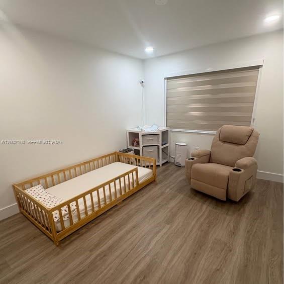 8650 Southwest 149th Avenue, Unit 310 Miami, FL 33193 - Photo 9 of 16 a bedroom with furniture and a wooden floor