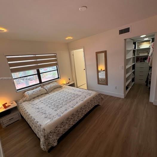 8650 Southwest 149th Avenue, Unit 310 Miami, FL 33193 - Photo 10 of 16 a bedroom with a bed and a dresser with wooden floor