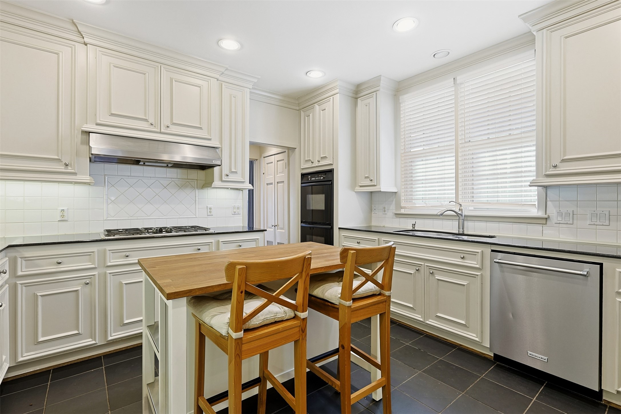 1311 Peden Street Houston, TX 77006 - Photo 14 of 21 a kitchen with stainless steel appliances granite countertop a stove a sink and white cabinets
