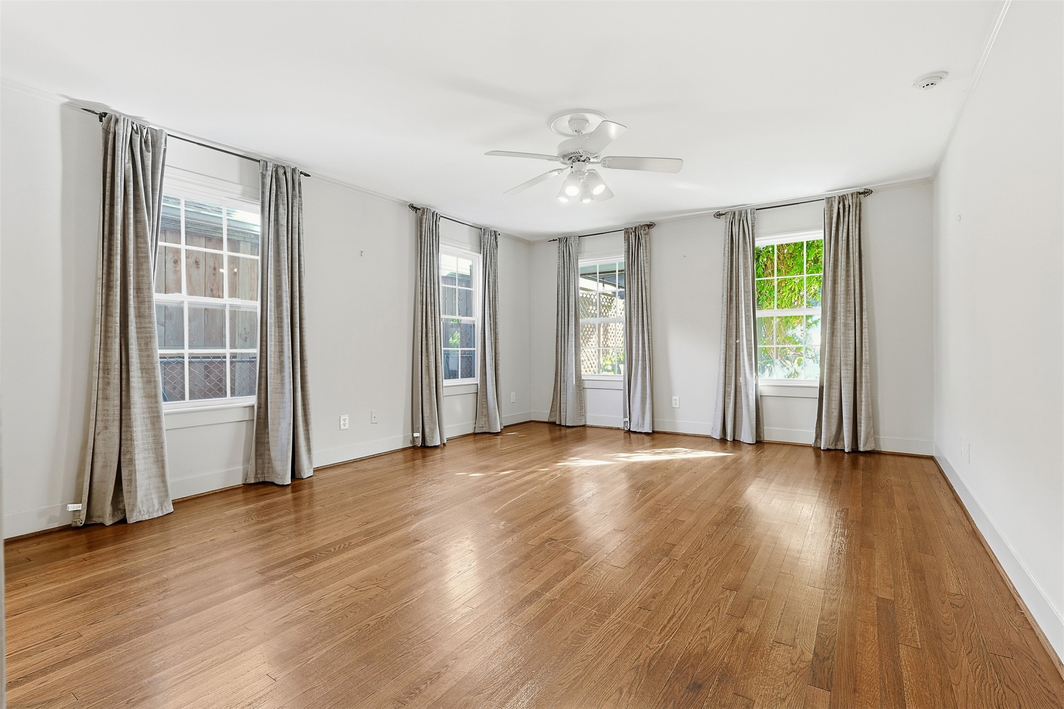 1311 Peden Street Houston, TX 77006 - Photo 8 of 21 a view of an empty room with wooden floor and a window