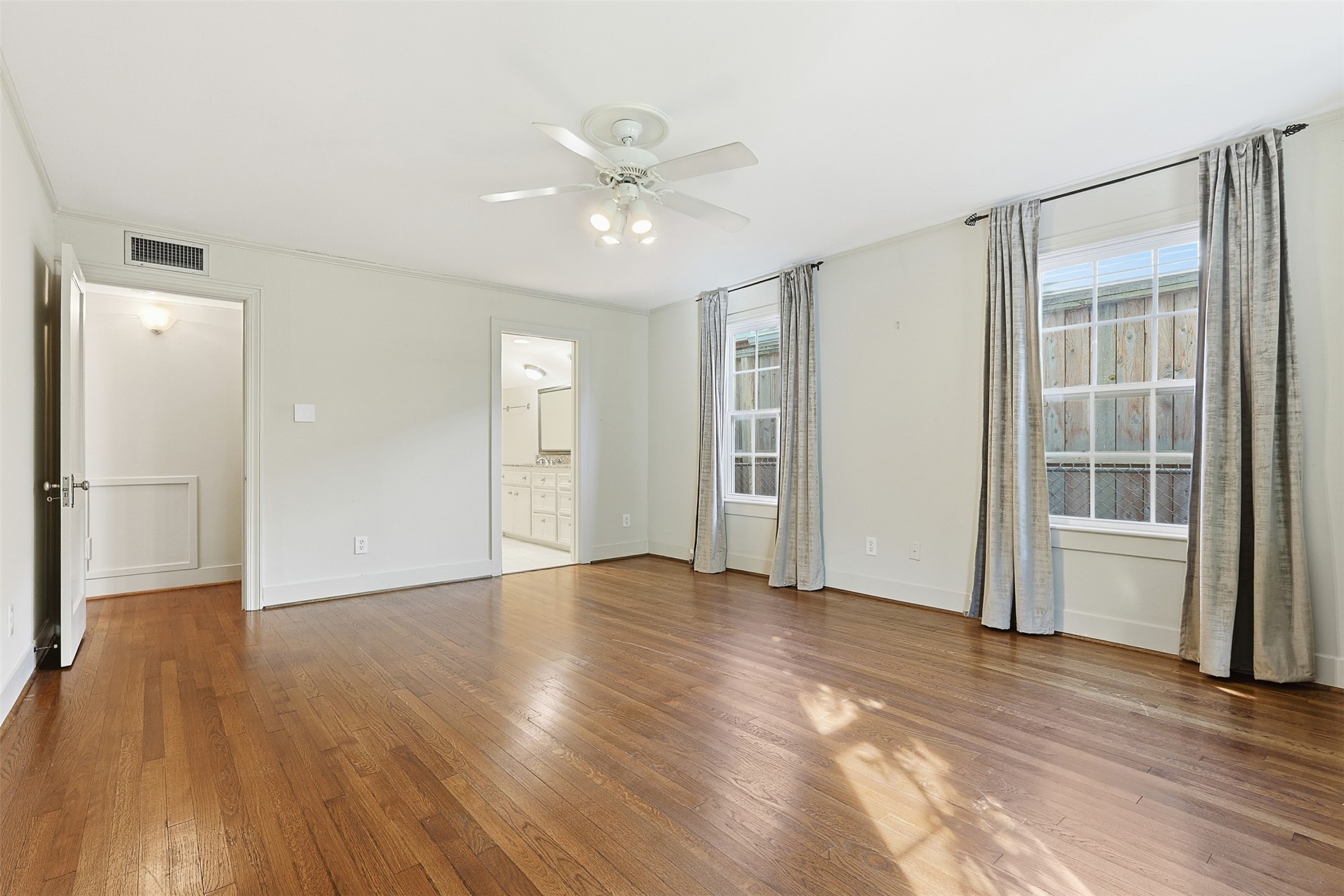 1311 Peden Street Houston, TX 77006 - Photo 9 of 21 a view of an empty room with wooden floor and a window