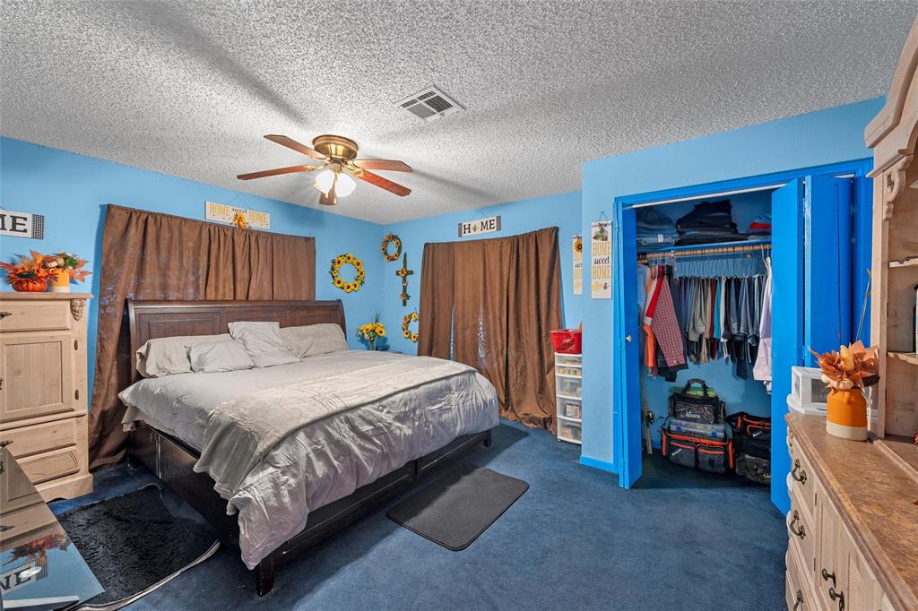 416 Capps Street Marlin, TX 76661 - Photo 12 of 25 a bedroom with a bed and a chandelier