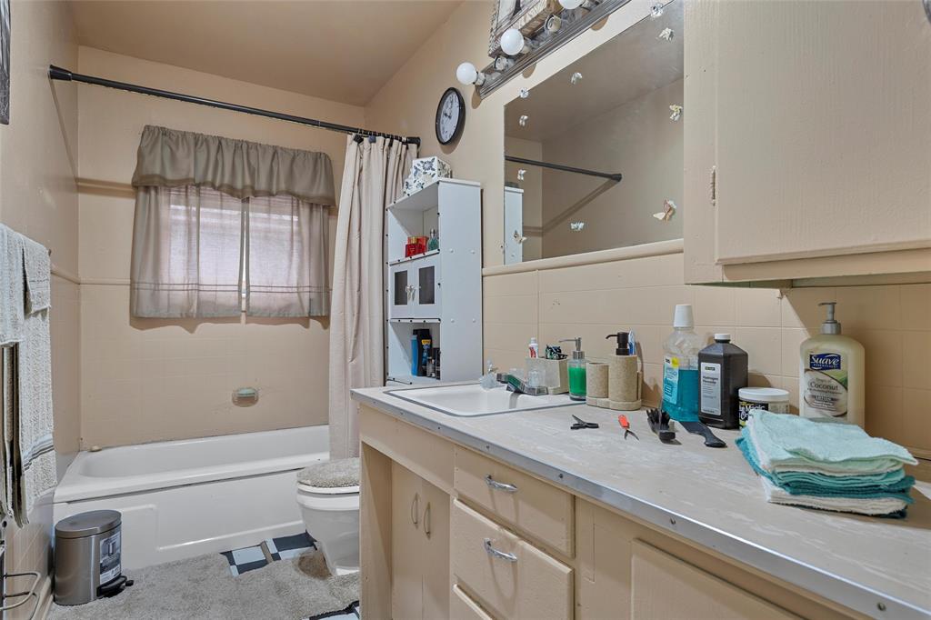 416 Capps Street Marlin, TX 76661 - Photo 23 of 25 a bathroom with a sink a toilet and shower
