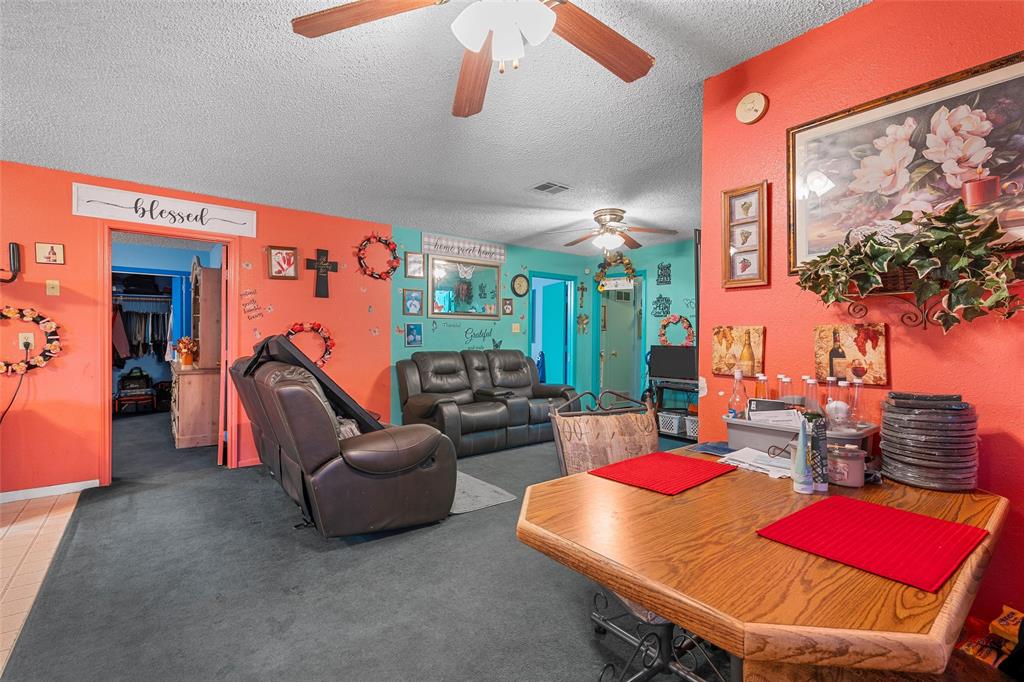 416 Capps Street Marlin, TX 76661 - Photo 6 of 25 a living room with furniture a chandelier and a wooden floor