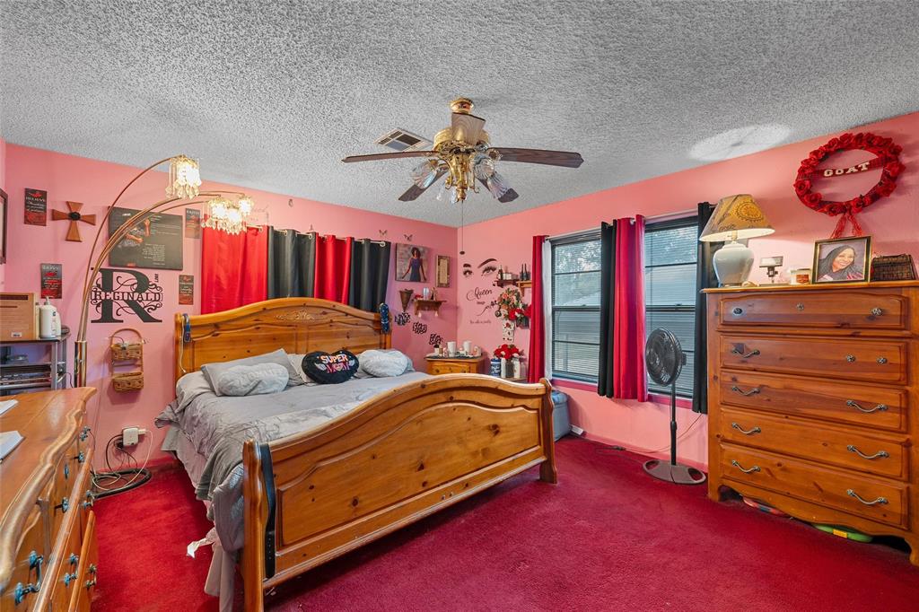 416 Capps Street Marlin, TX 76661 - Photo 9 of 25 a bedroom with a bed and a chandelier