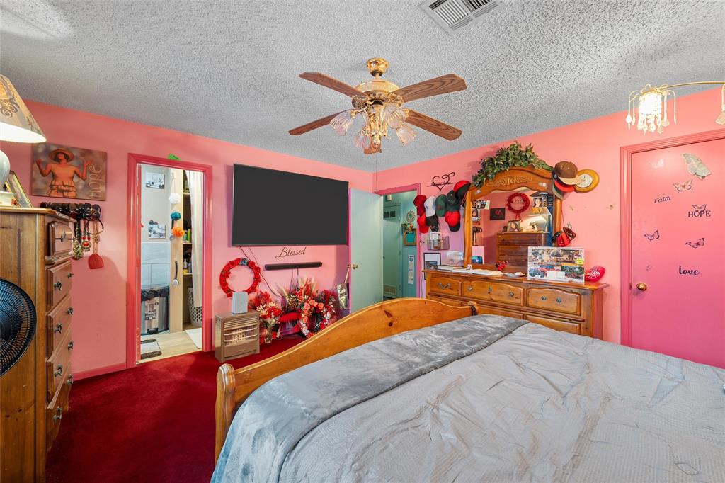 416 Capps Street Marlin, TX 76661 - Photo 10 of 25 a bedroom with a bed and a flat tv screen on dresser