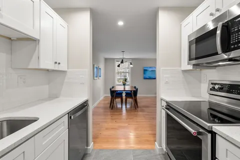 a kitchen with granite countertop a stove and a sink