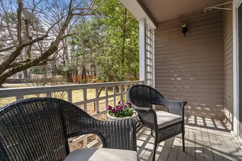 a view of a balcony with furniture