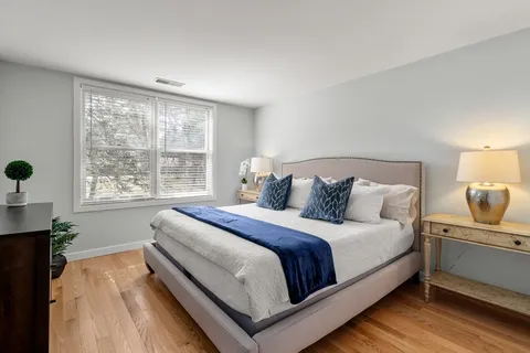 a bedroom with a bed and window