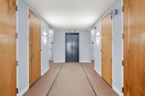 a view of hallway with wooden floor