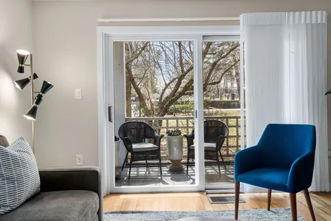 a living room with furniture and a floor to ceiling window