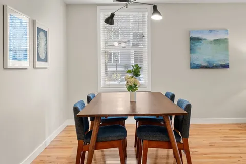 a view of a dining room with furniture and wooden floor