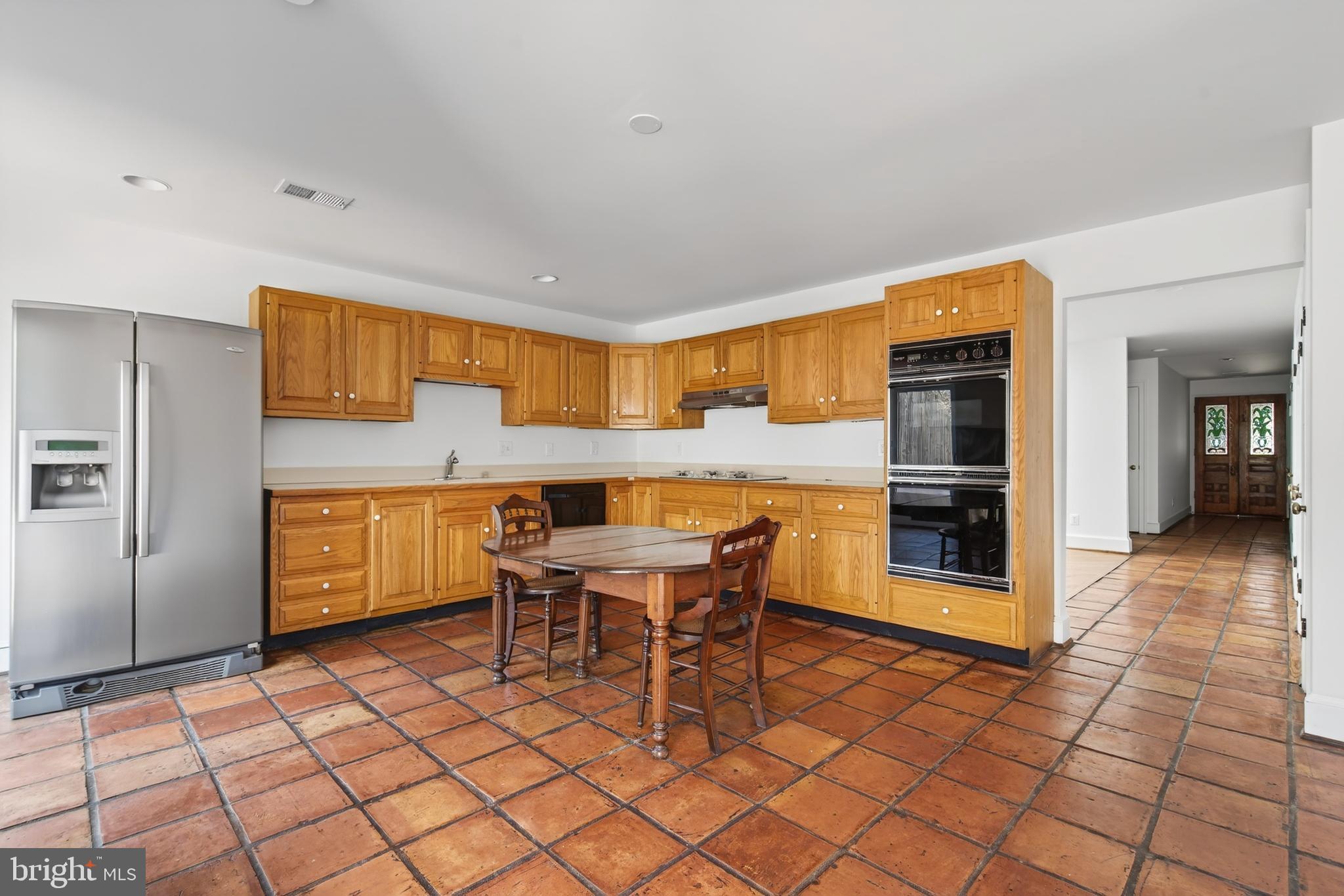 306 9th Street Southeast Washington, DC 20003 - Photo 16 of 50 a kitchen with granite countertop a sink cabinets and refrigerator