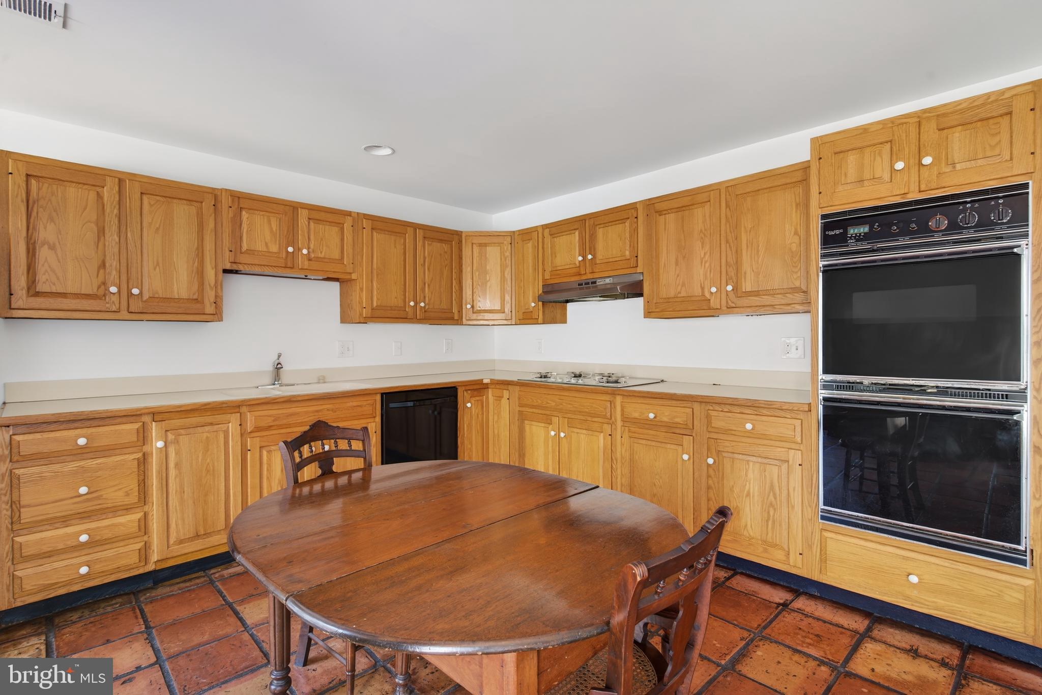 306 9th Street Southeast Washington, DC 20003 - Photo 17 of 50 a kitchen with stainless steel appliances a stove a sink a microwave and wooden cabinets