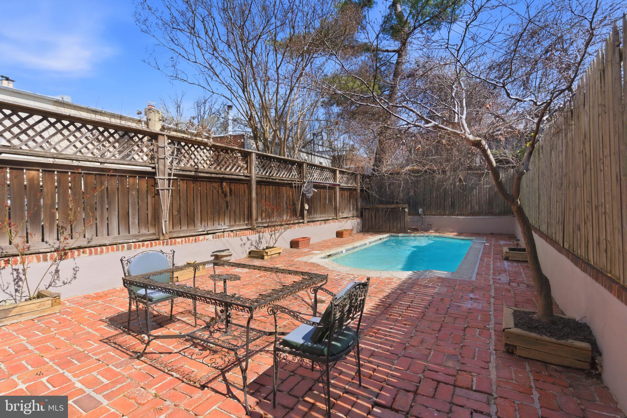 306 9th Street Southeast Washington, DC 20003 - Photo 19 of 50 a view of a backyard with table and chairs with wooden fence and plants