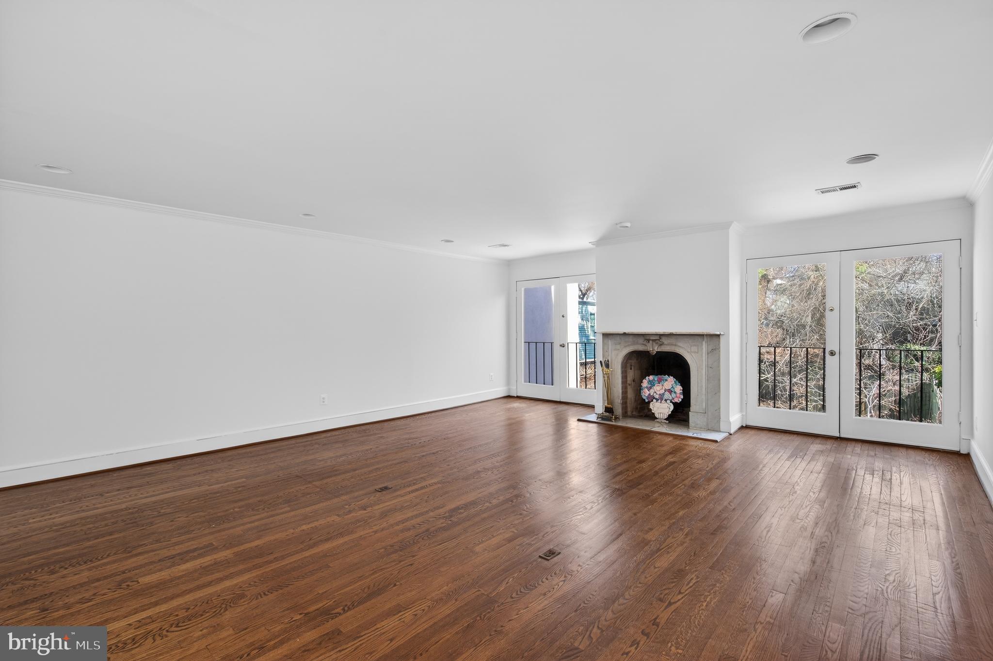 306 9th Street Southeast Washington, DC 20003 - Photo 27 of 50 a view of an empty room with wooden floor and a fireplace