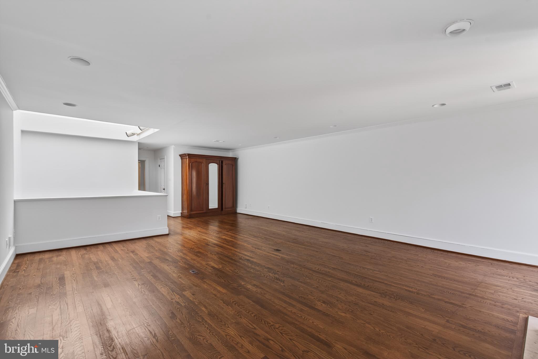 306 9th Street Southeast Washington, DC 20003 - Photo 28 of 50 a view of an empty room with wooden floor and a window