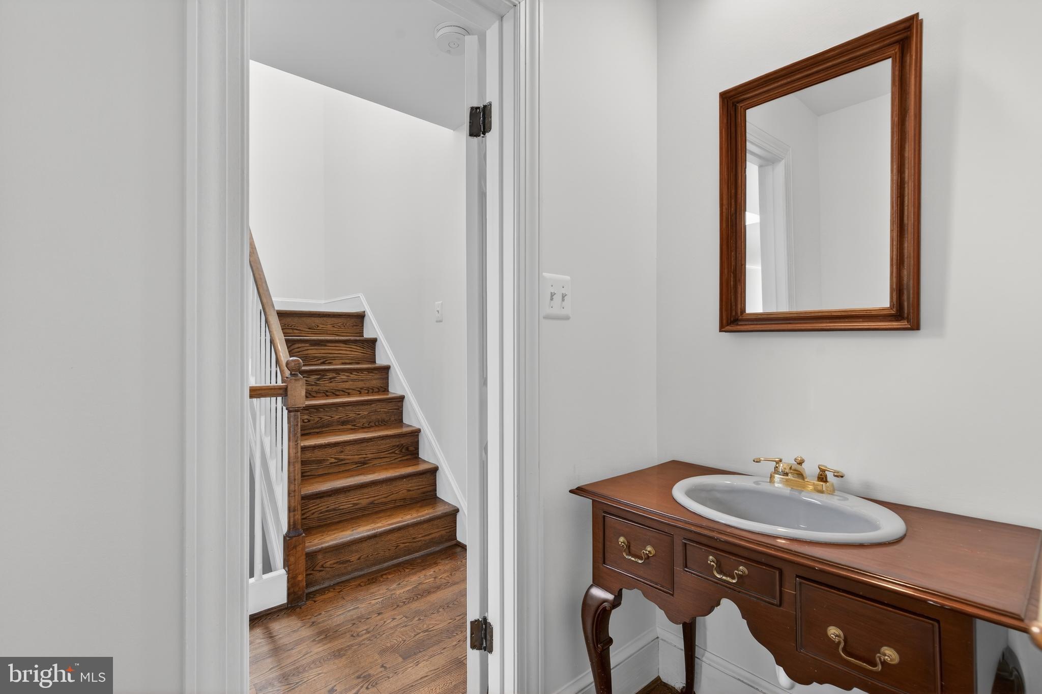 306 9th Street Southeast Washington, DC 20003 - Photo 30 of 50 a bathroom with a sink a mirror and a toilet