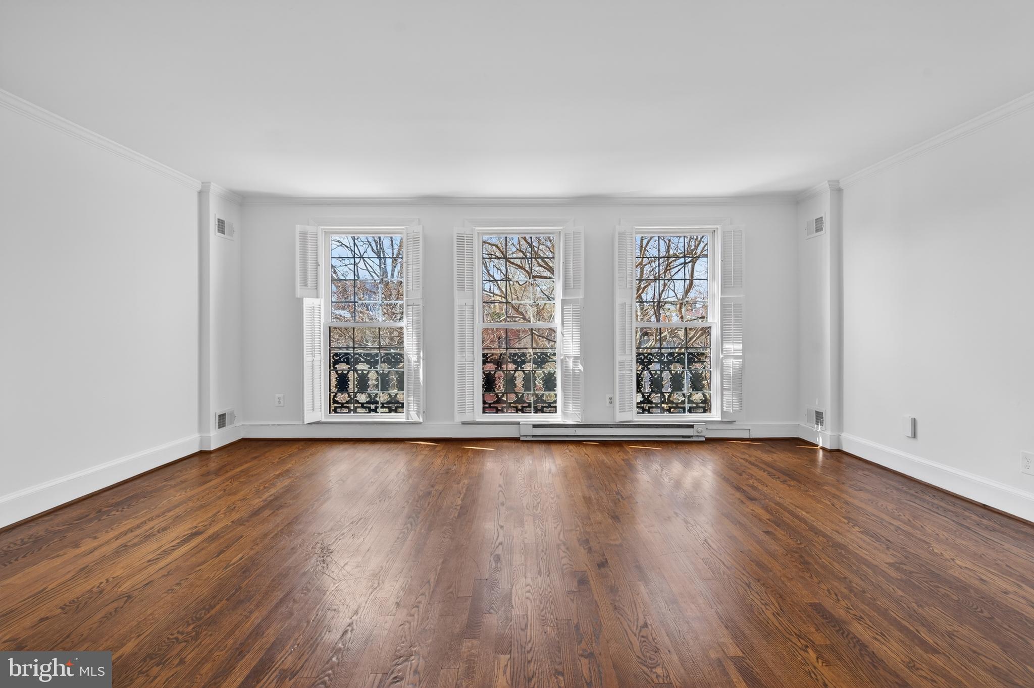 306 9th Street Southeast Washington, DC 20003 - Photo 36 of 50 a view of an empty room with wooden floor and a window