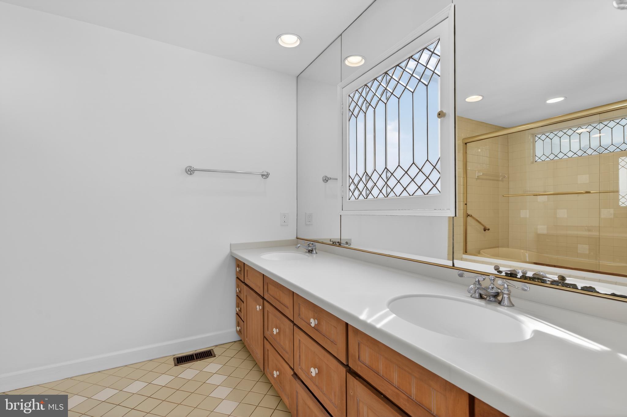 306 9th Street Southeast Washington, DC 20003 - Photo 44 of 50 a bathroom with a granite countertop sink a mirror and a bathtub