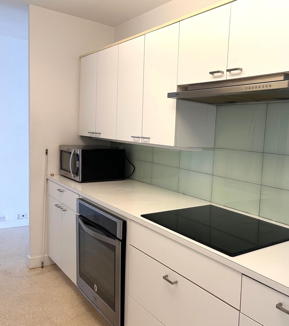 910 North Lake Shore Drive, Unit 2220 Chicago, IL 60611 - Photo 11 of 21 a kitchen with a sink and a microwave