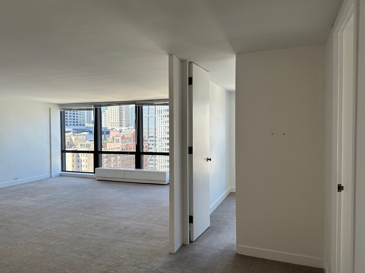 910 North Lake Shore Drive, Unit 2220 Chicago, IL 60611 - Photo 7 of 21 wooden floor in an empty room with a window