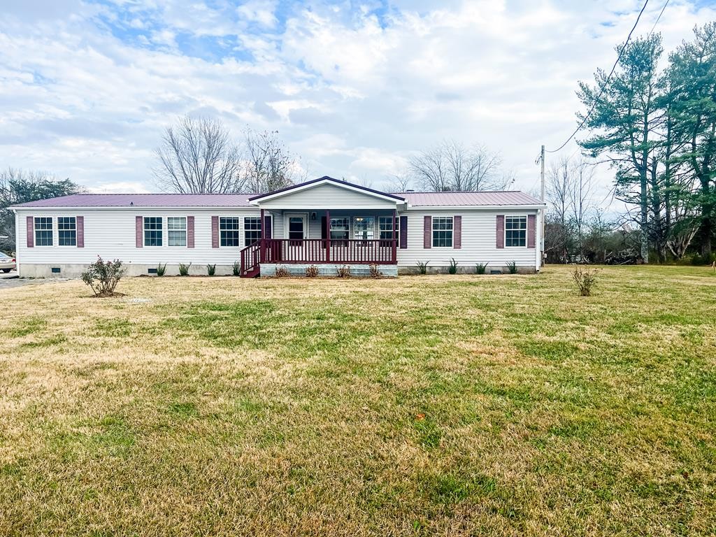 725 Hulon Ferrell Road Baxter, TN 38544 - Photo 1 of 31 a front view of a house with a garden and trees