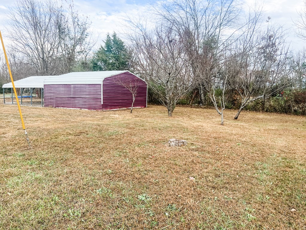 725 Hulon Ferrell Road Baxter, TN 38544 - Photo 27 of 31 a backyard of a house with large trees