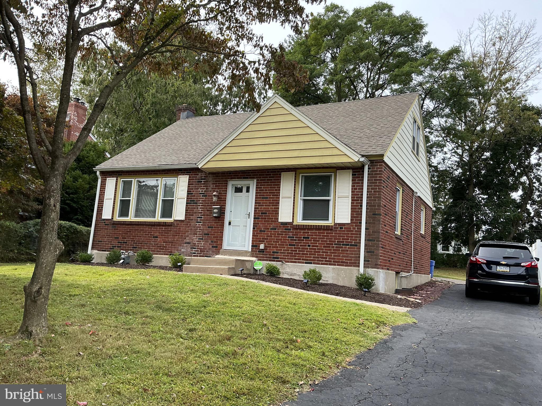 728 Oak Way Havertown, PA 19083 - Photo 2 of 26 a front view of a house with a yard and garage