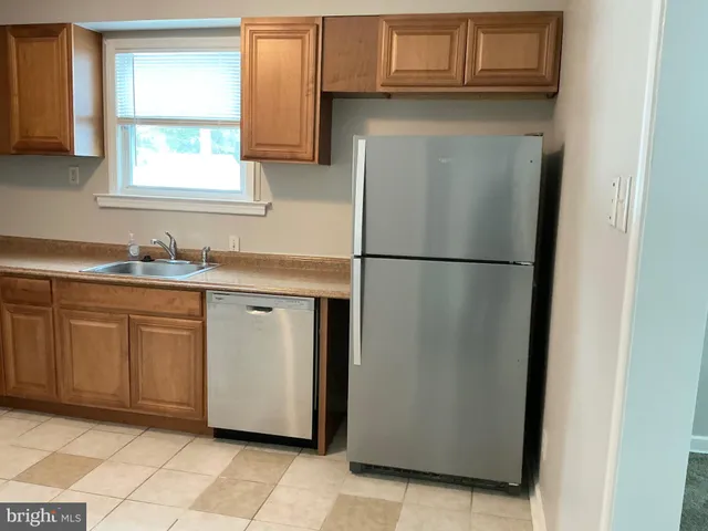a white refrigerator freezer sitting inside of a kitchen