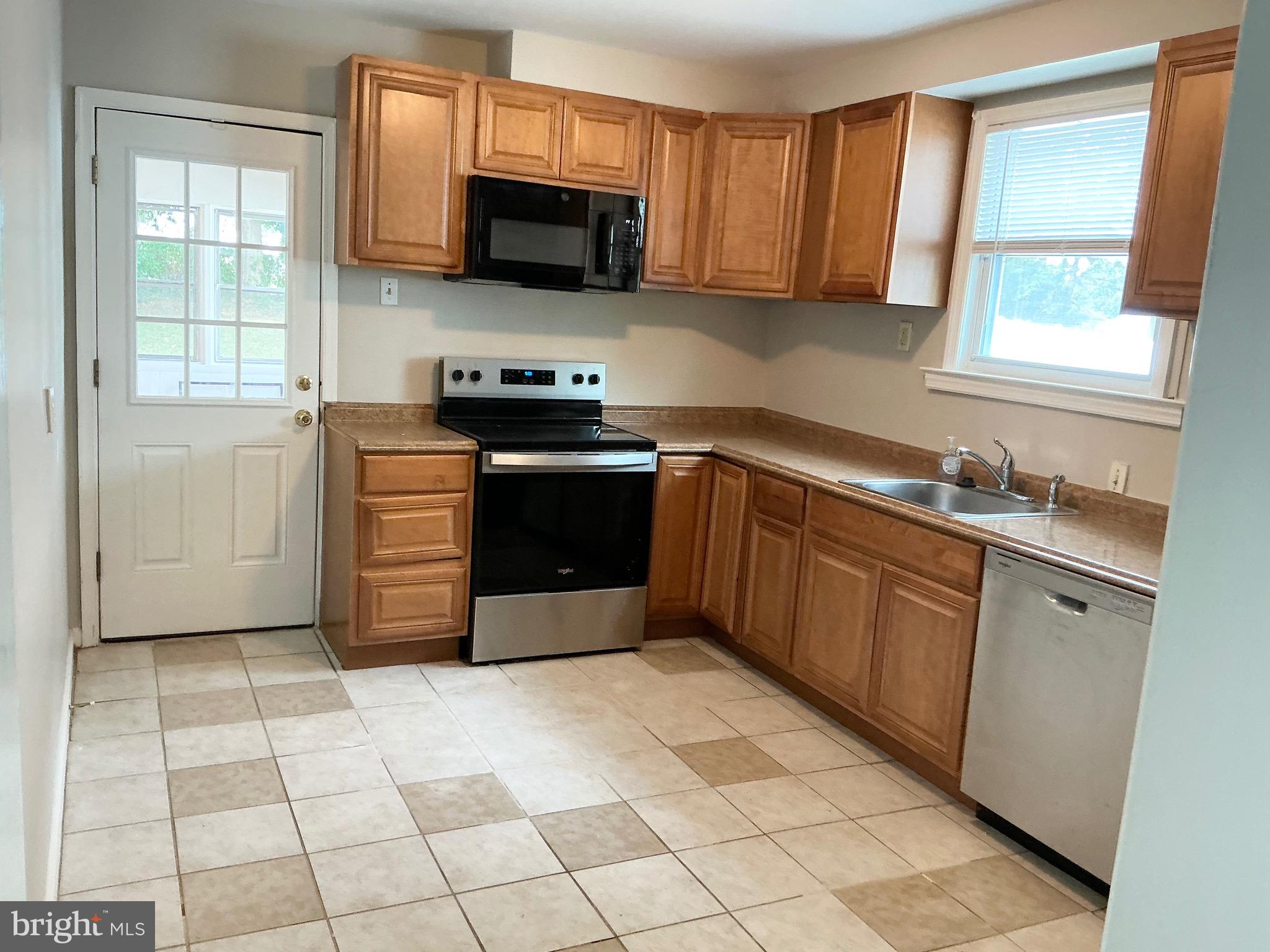 728 Oak Way Havertown, PA 19083 - Photo 7 of 26 a kitchen with stainless steel appliances granite countertop a stove a sink and a microwave