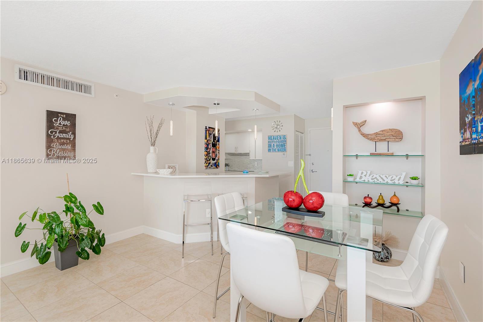 6917 Collins Avenue, Unit 511 Miami Beach, FL 33141 - Photo 17 of 24 a dining room with furniture and a potted plant