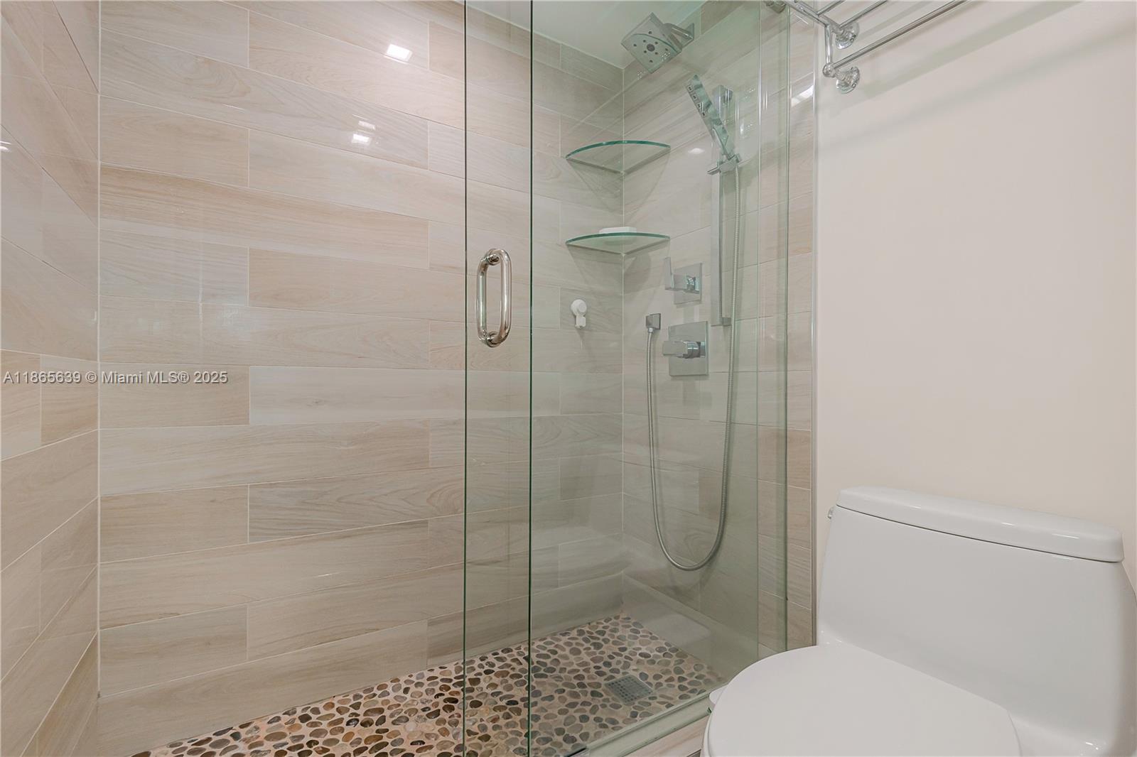 6917 Collins Avenue, Unit 511 Miami Beach, FL 33141 - Photo 23 of 24 a bathroom with a shower and toilet