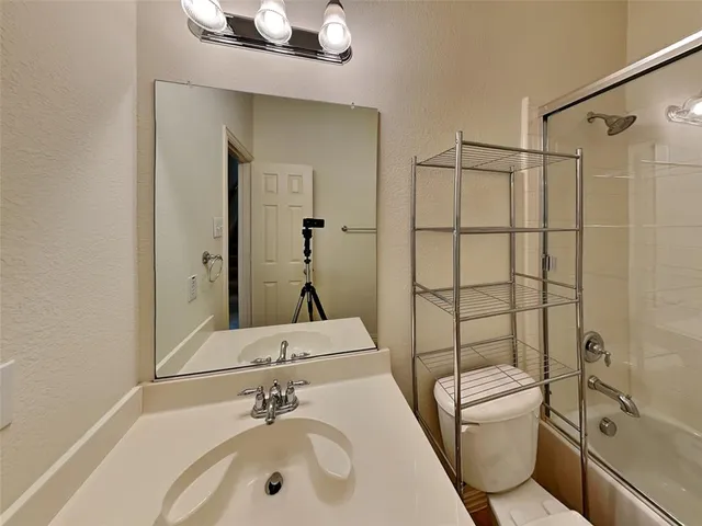 a bathroom with a toilet and a bath tub