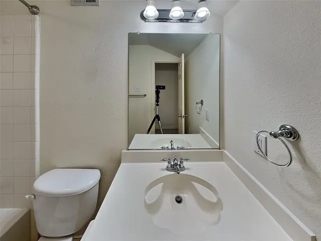 a view of a room with a ceiling fan