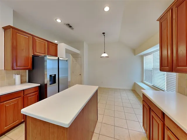 a kitchen with stainless steel appliances a refrigerator and a sink