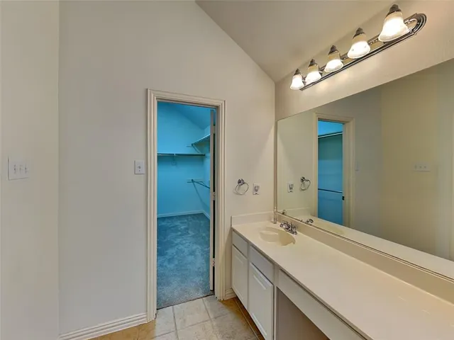 a bathroom with a double vanity sink and a mirror