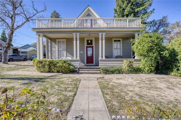 a front view of a house with a garden
