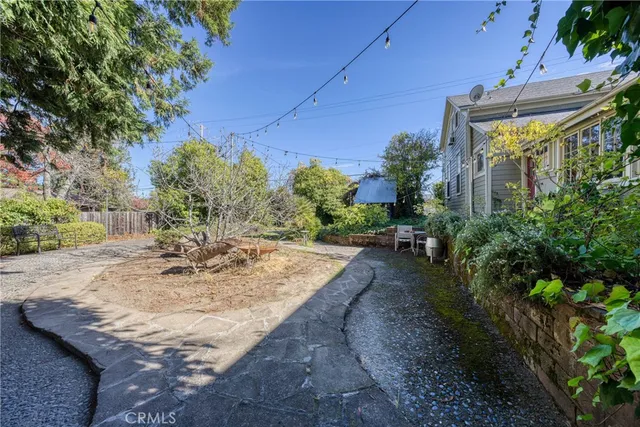 a view of a patio with a table chairs and a backyard